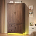 LIKIMIO Farmhouse Wardrobe Closet with Doors, 70" Bedroom Armoires with LED Lights and Hanging Rod, Wooden Large Wardrobe Cabinet with 2 Drawers and 1 Cabinet, Walnut